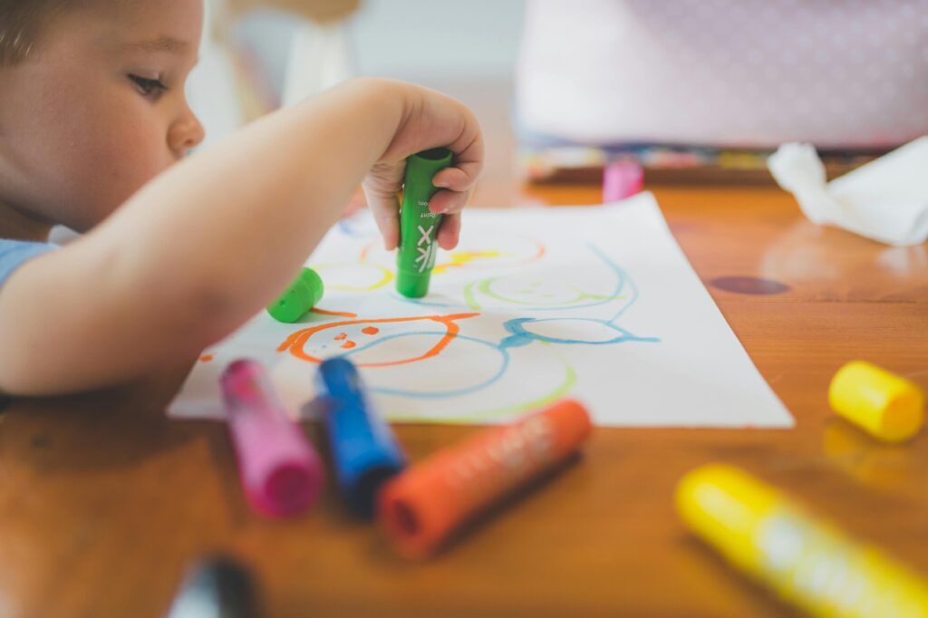 Toddler painting at an early learning centre in Melton, exploring creativity and independence through hands-on activities